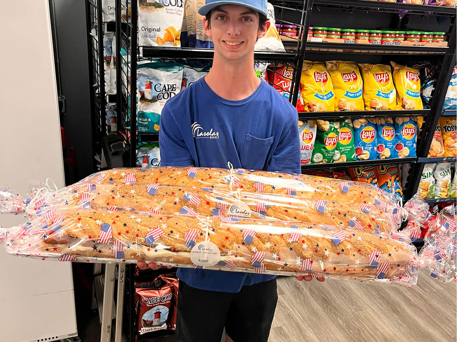 Employee holding July 4th Subs